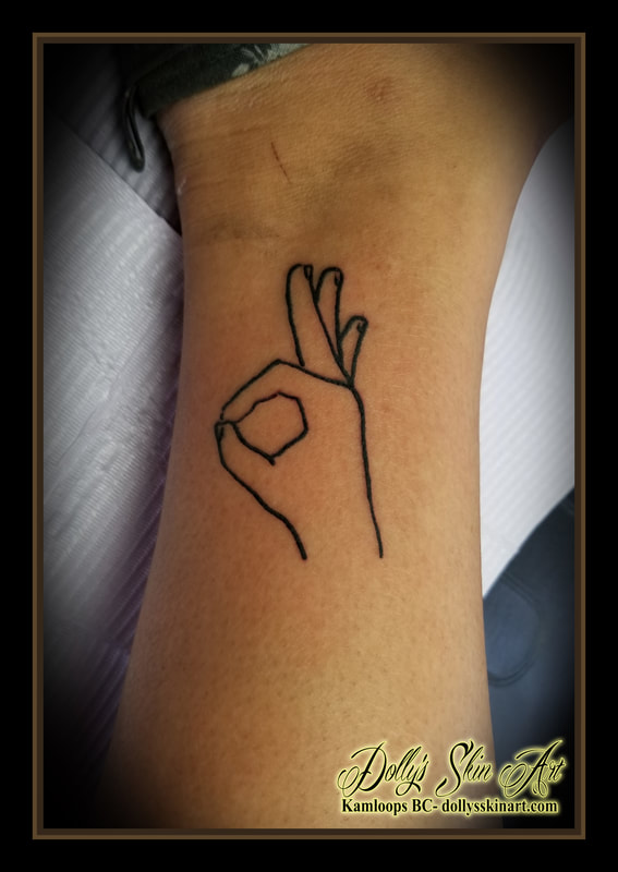 a ok hand symbol outline black work ankle tattoo kamloops tattoo dolly's skin art