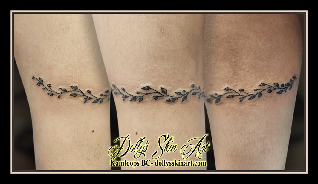 flower band tattoo black and grey shading wrapping around tattoo kamloops dolly's skin art