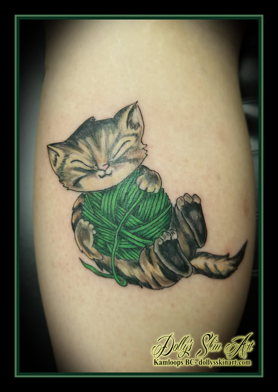cat kitten kitty colour brown green yarn animated playing leg calf tattoo kamloops tattoo dolly's skin art