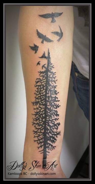 black evergreen tree ravens birds flying forearm tattoo