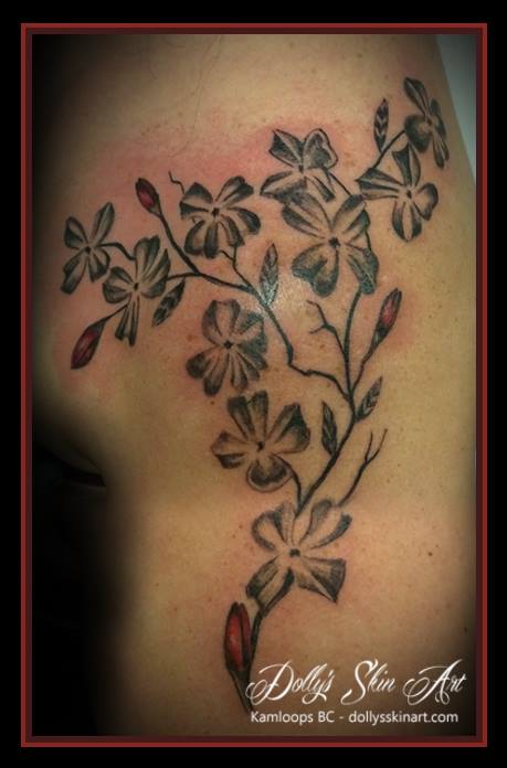 black and grey with red cherry blossom shoulder cap tattoo kamloops dolly's skin art