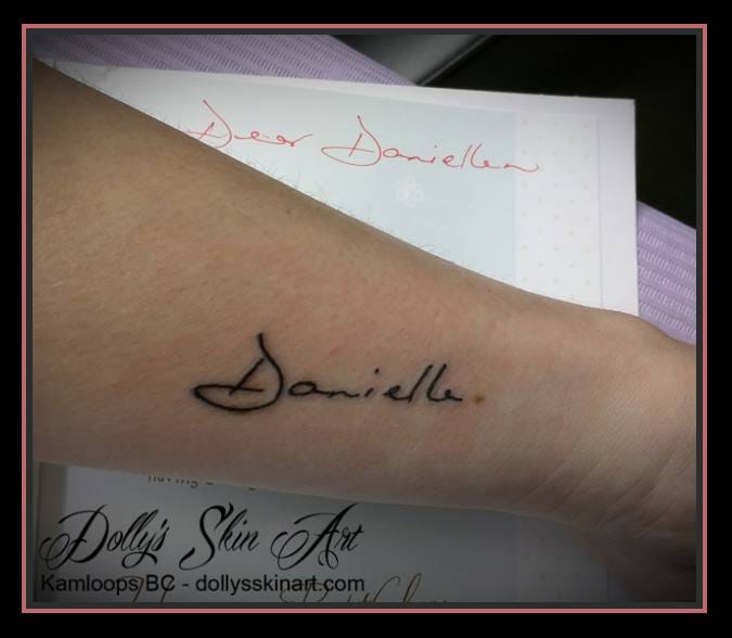 Janna's Danielle in her mom's hand writing black font lettering signature tattoo small kamloops dolly's skin art