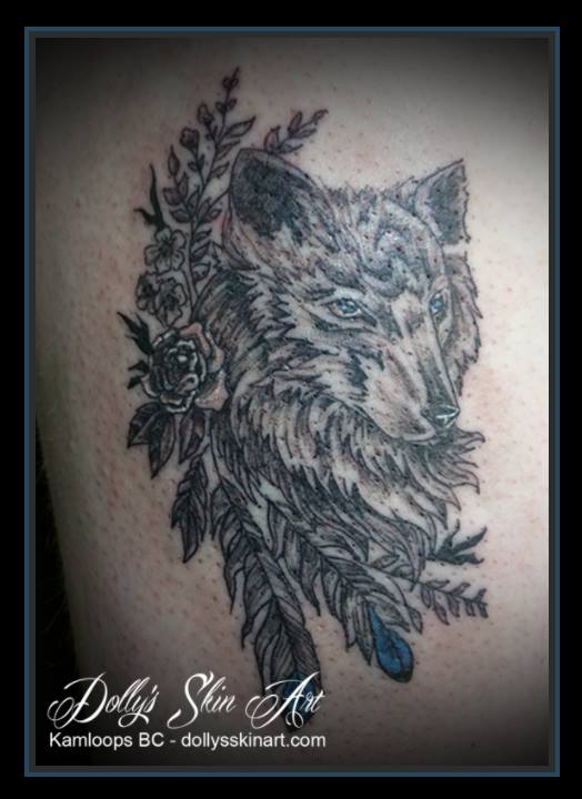 black and grey wolf with blue and white flower feathers tattoo kamloops dolly's skin art