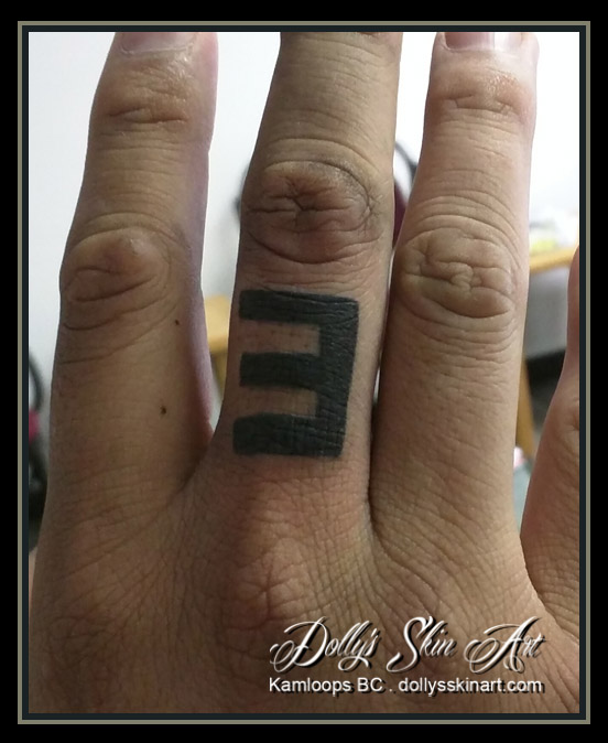 backwards e black finger tattoo