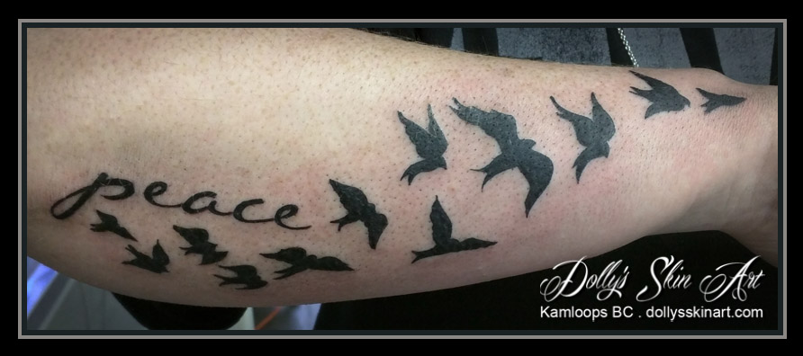 black peace birds arm tattoo