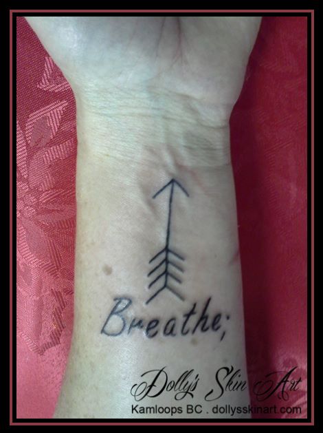 wrist tattoo breathe arrow