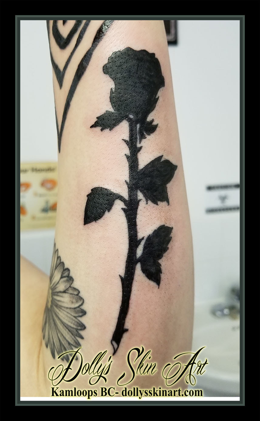 solid black fill rose forearm silhouette tattoo kamloops dolly's skin art