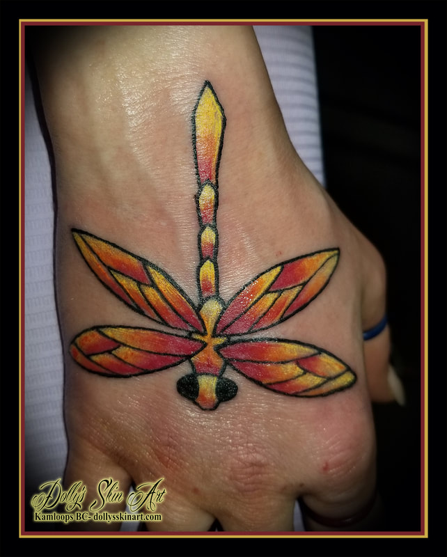 fire dragonfly colour red orange yellow black hand tattoo kamloops tattoo dolly's skin art