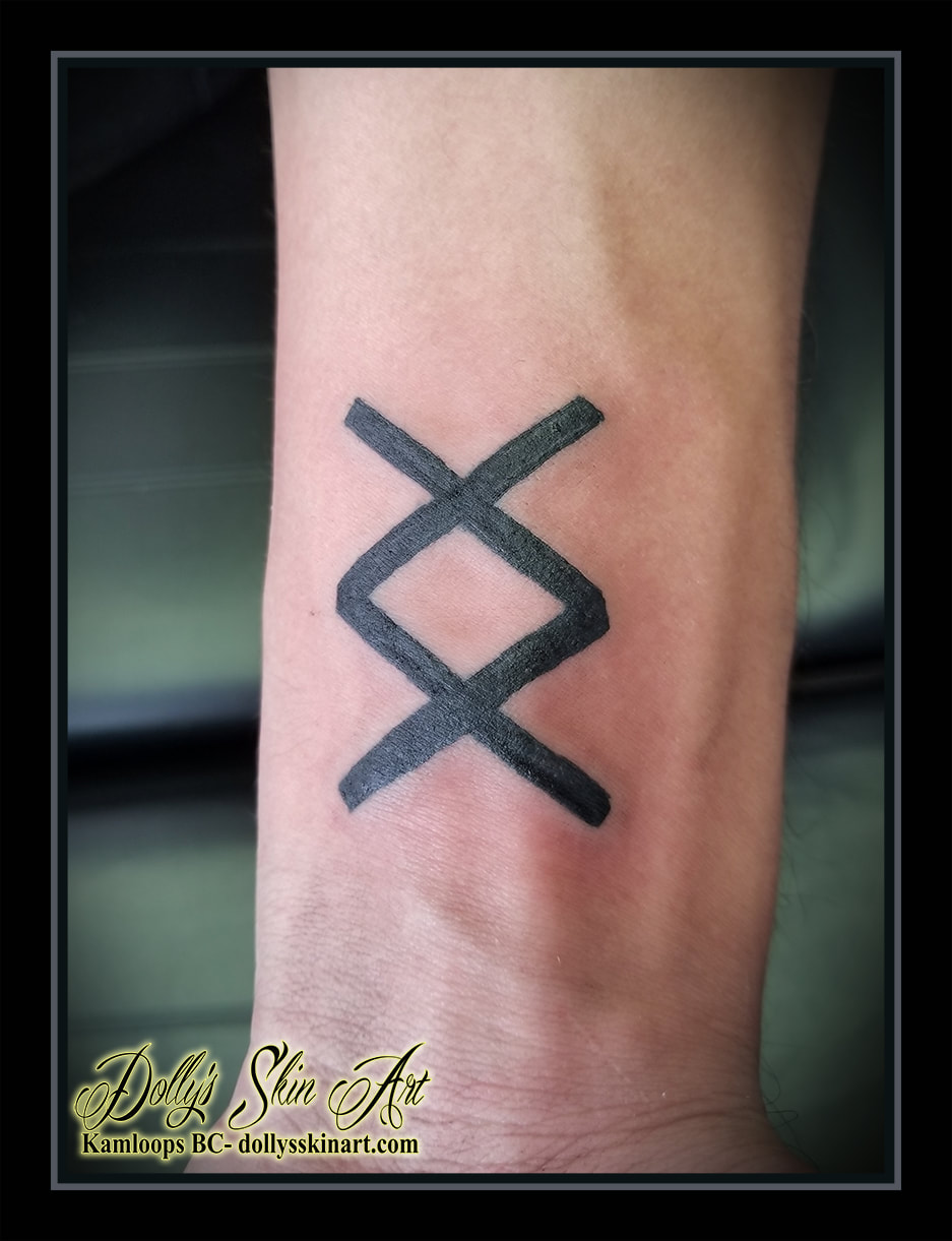 inguz rune xx black linework wrist greek lettering tattoo kamloops dolly's skin art
