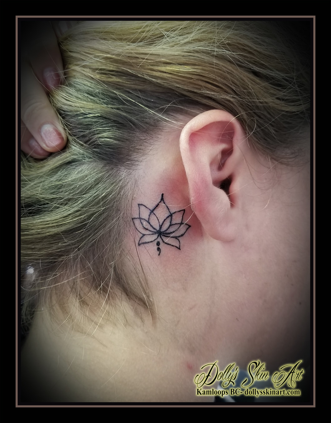 lotus flower small linework black back of bear behind semi colon outline tattoo kamloops tattoo dolly's skin art