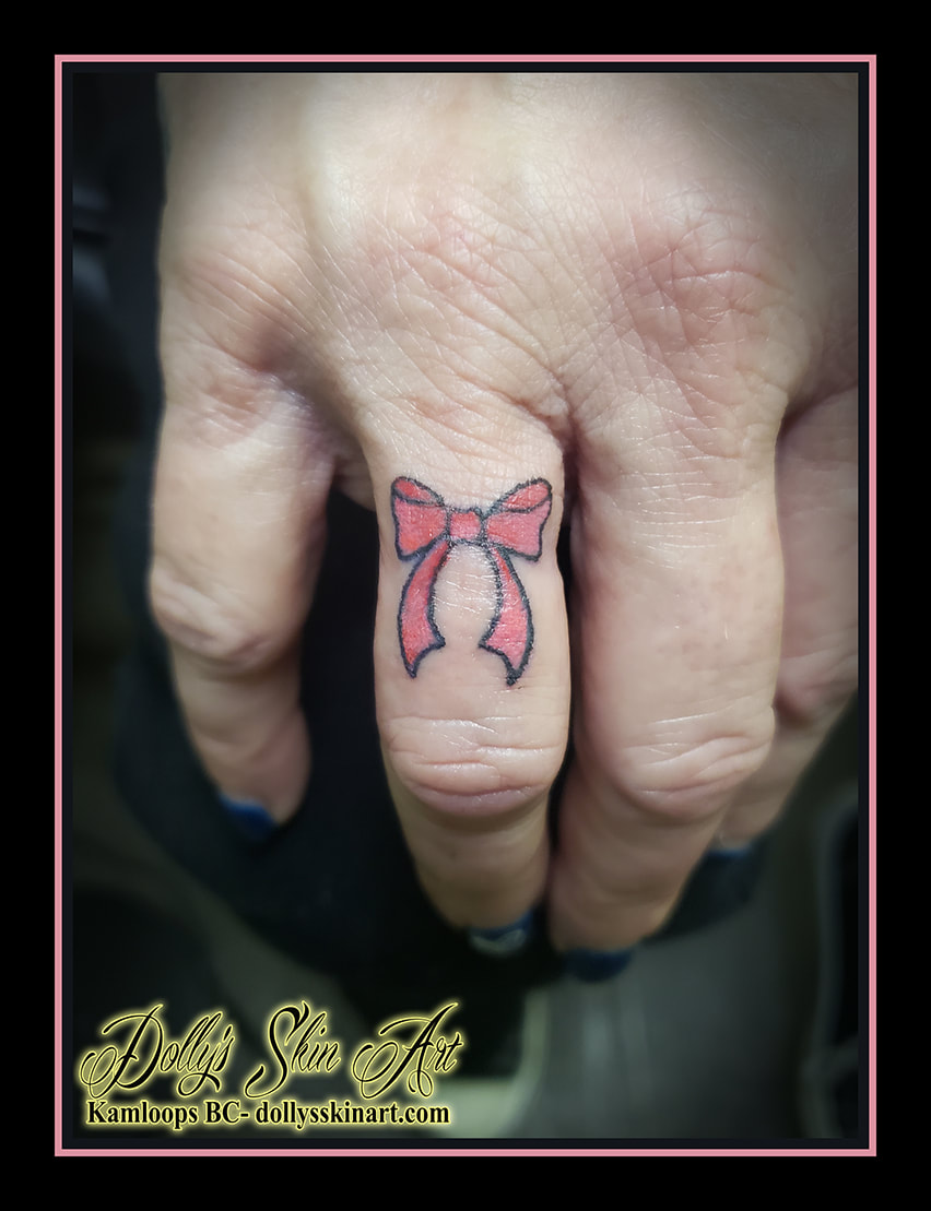 pink bow tattoo finger black colour tattoo dolly's skin art kamloops