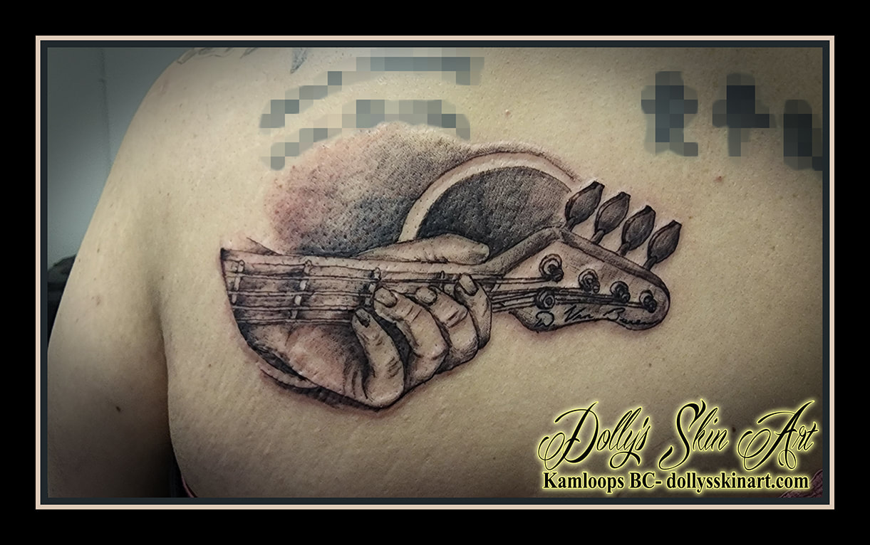 guitar tattoo hand playing black and grey guitar neck family shading linework tattoo dolly's skin art kamloops