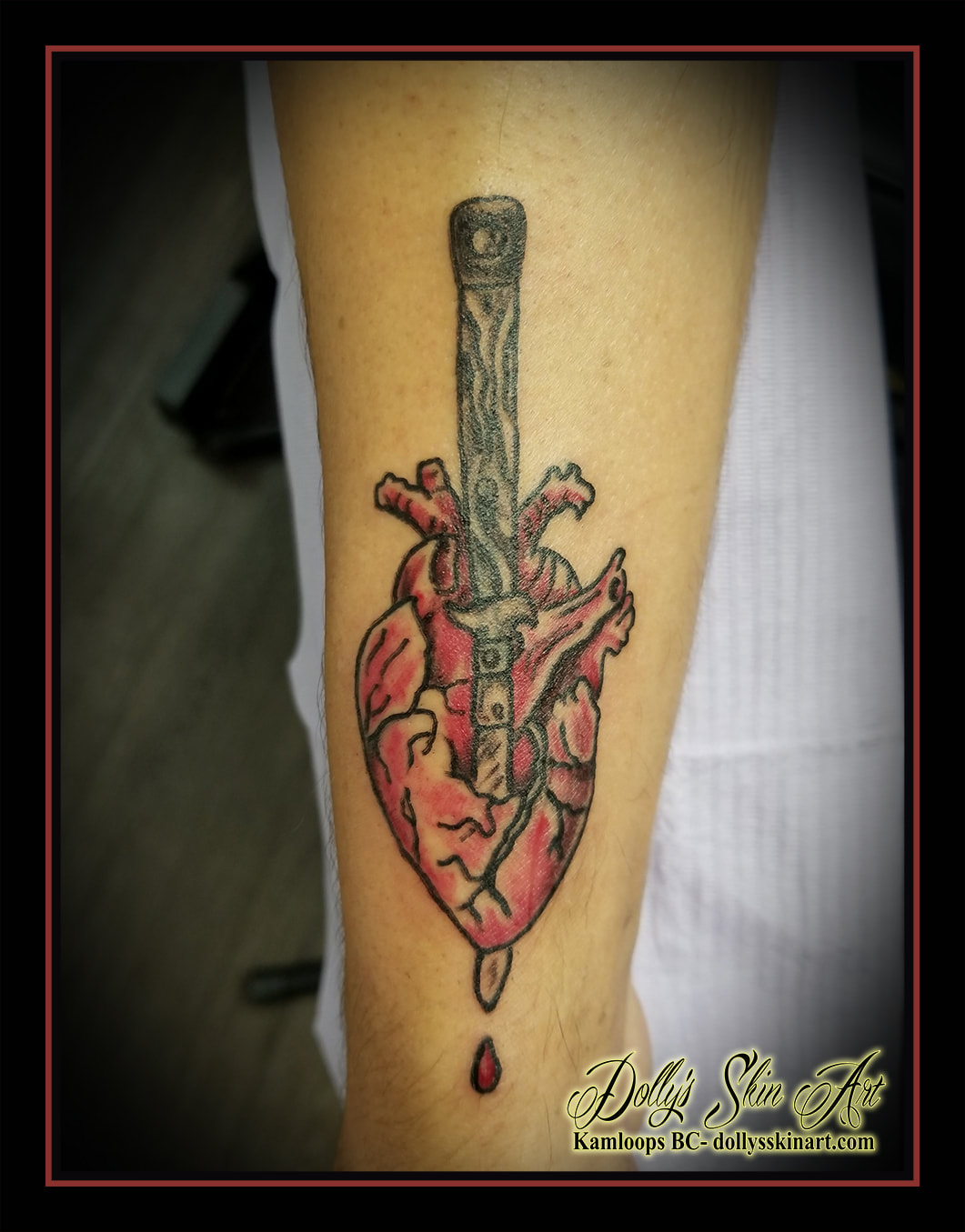 traditional heart switchblade anatomical knife in heart red black shaded colour forearm tattoo kamloops tattoo dolly's skin art