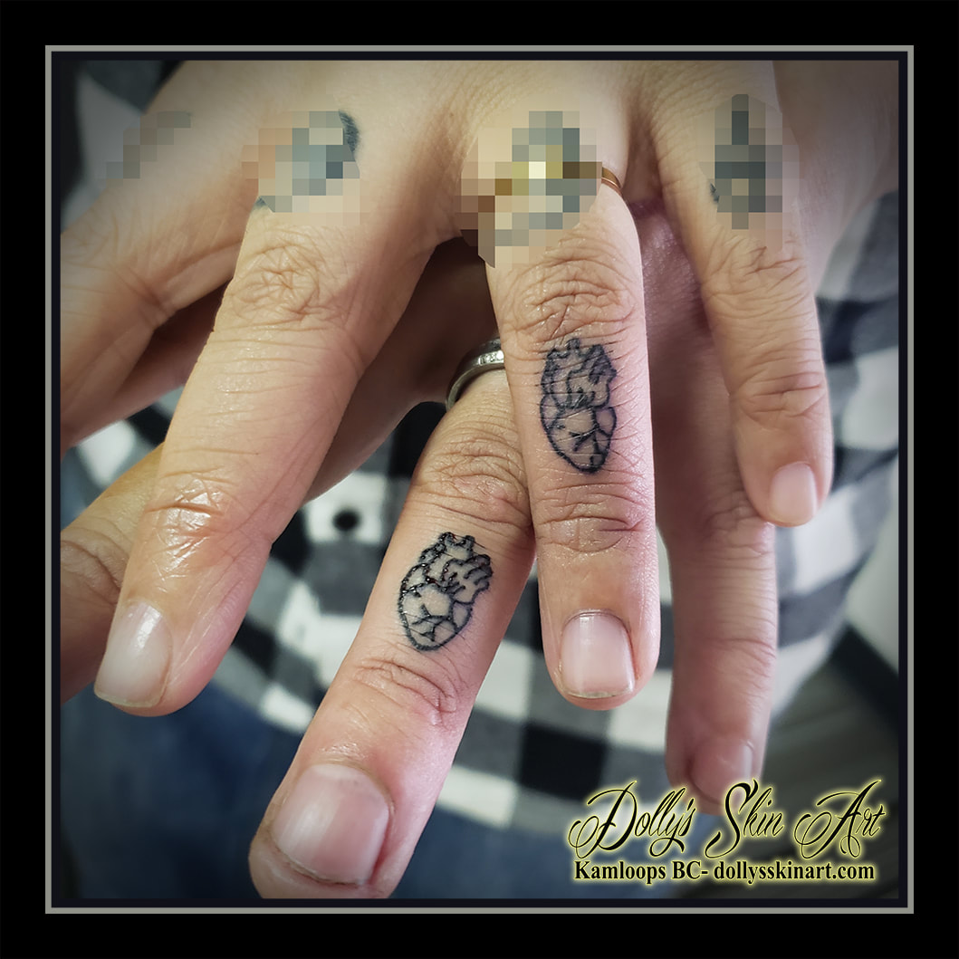 anatomical heart tattoo matching finger outline linework black tattoo kamloops dolly's skin art