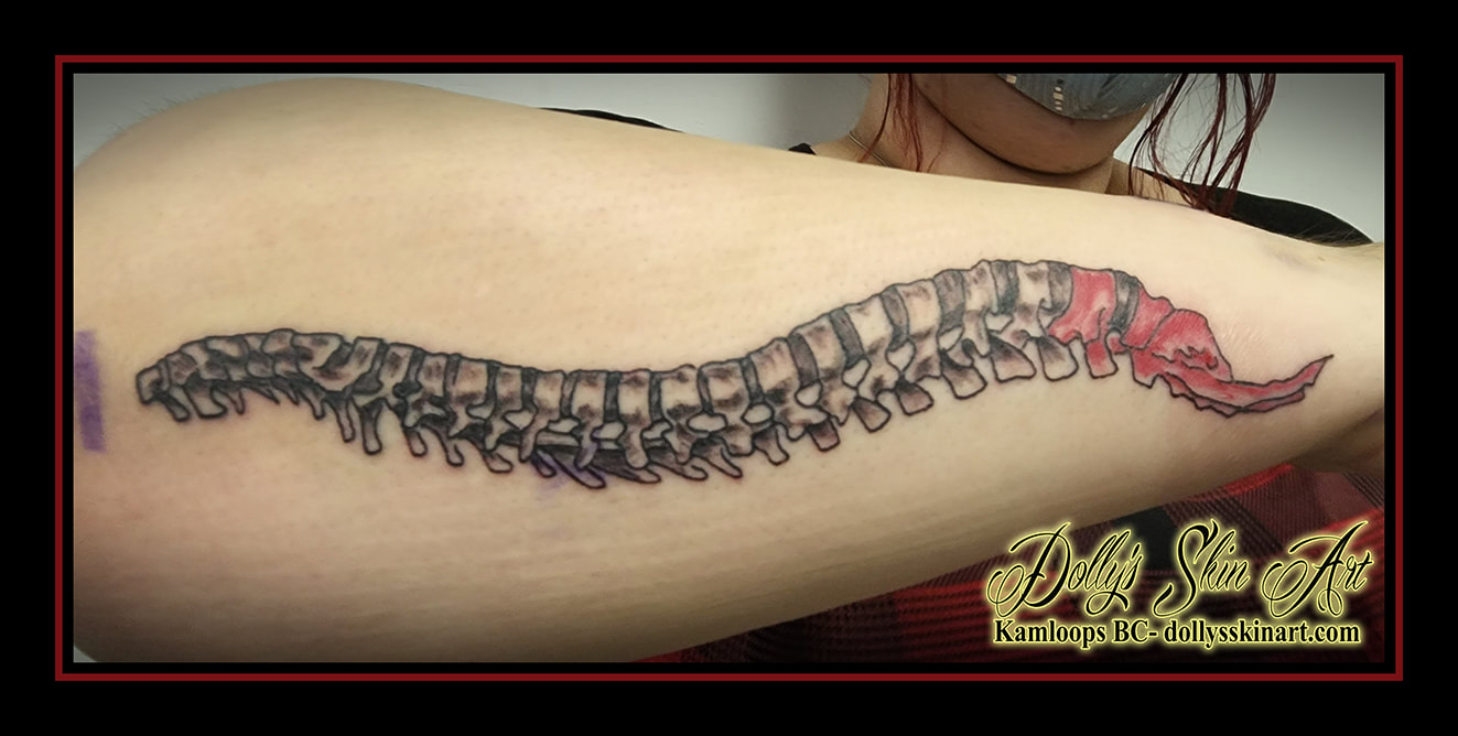 spine tattoo skeletal anatomical forearm black and grey red shading tattoo dolly's skin art kamloops