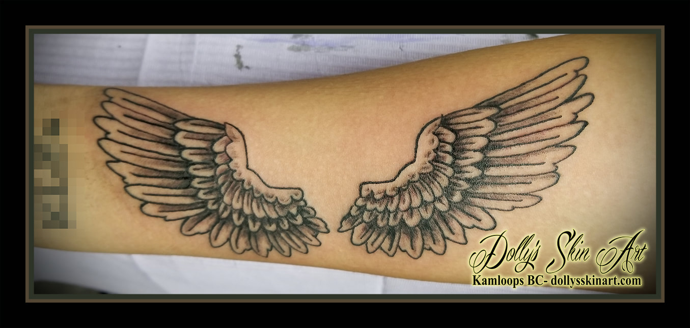 wings feather black and grey shaded line work forearm memorial tattoo kamloops tattoo dolly's skin art