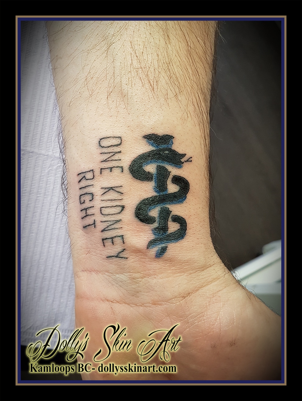 medical alert staff of Asclepius black blue one kidney right lettering font wrist kamloops tattoo dolly's skin art