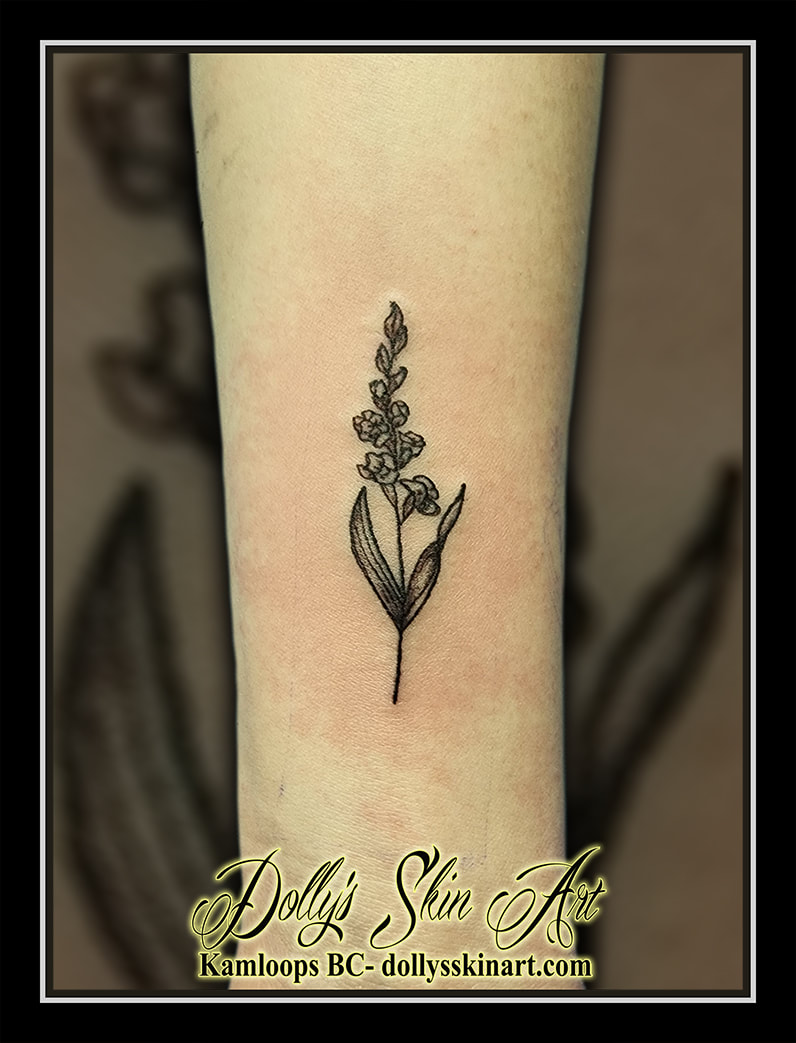 gladiolus tattoo black flower small linework shading forearm tattoo kamloops dolly's skin art