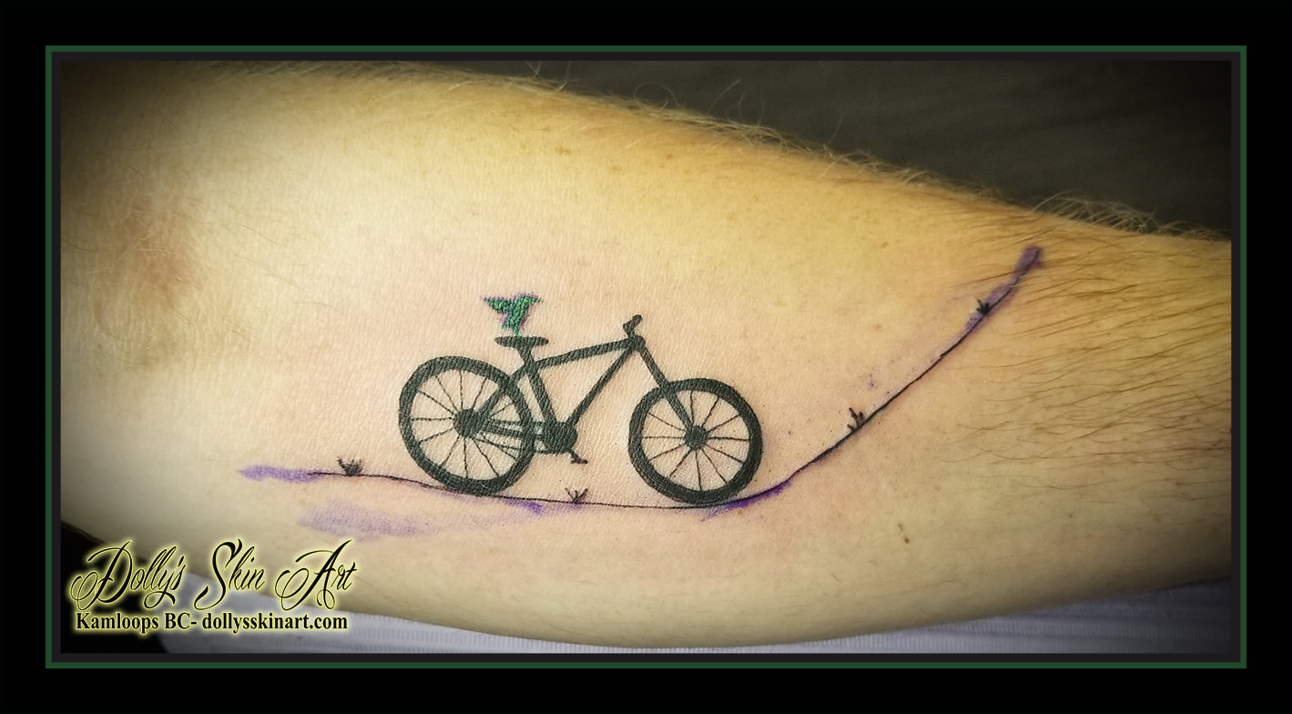matching bicycle tattoos black bike blue green bird road forearm tattoo kamloops dolly's skin art