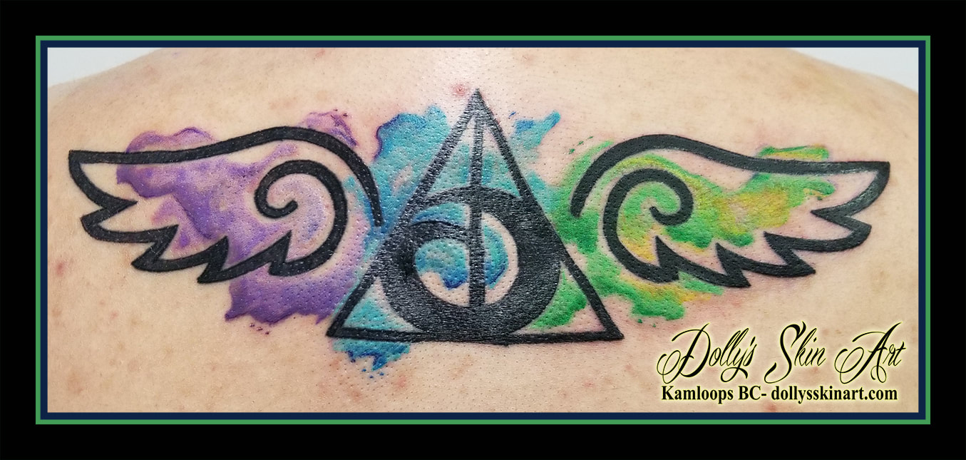 harry potter deathly hallows golden snitch black and water colour watercolor tribal style purple green yellow blue black tattoo kamloops tattoo dolly's skin art
