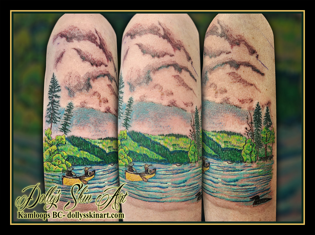 lake scene tattoo nature forest canoe loon colour blue yellow green black shading brown yellow shoulder bicep tattoo kamloops dolly's skin art