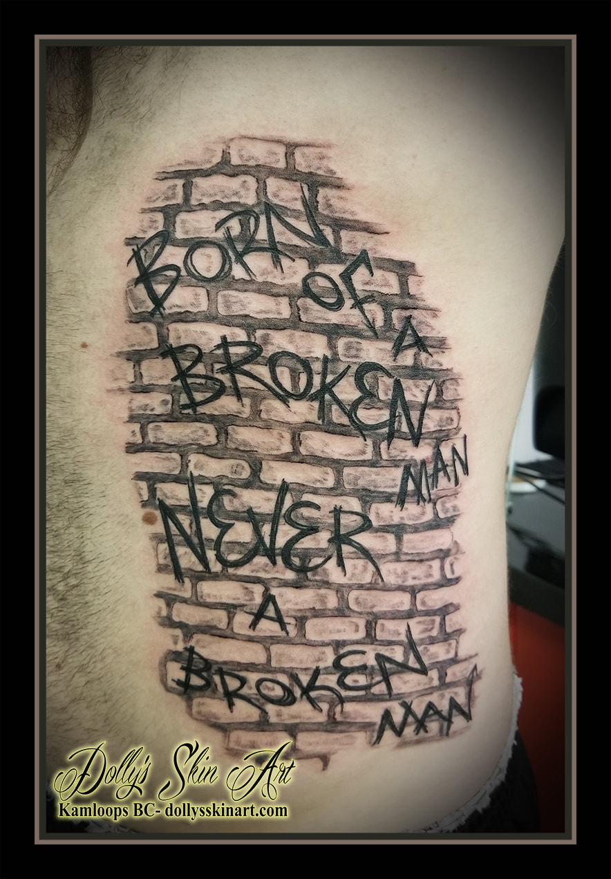 graffiti tattoo brick wall born of a broken man never a broken man black and grey shading brickwall paint lettering font script tattoo kamloops dolly's skin art