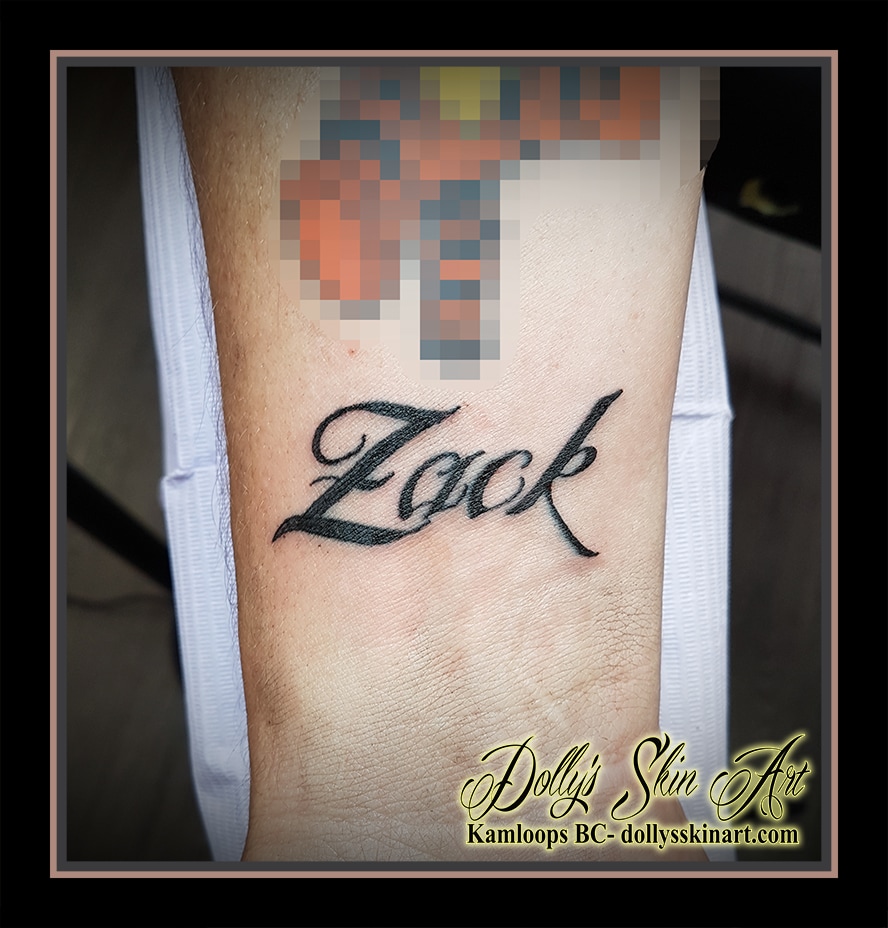 black font lettering Zack wrist script tattoo kamloops dolly's skin art