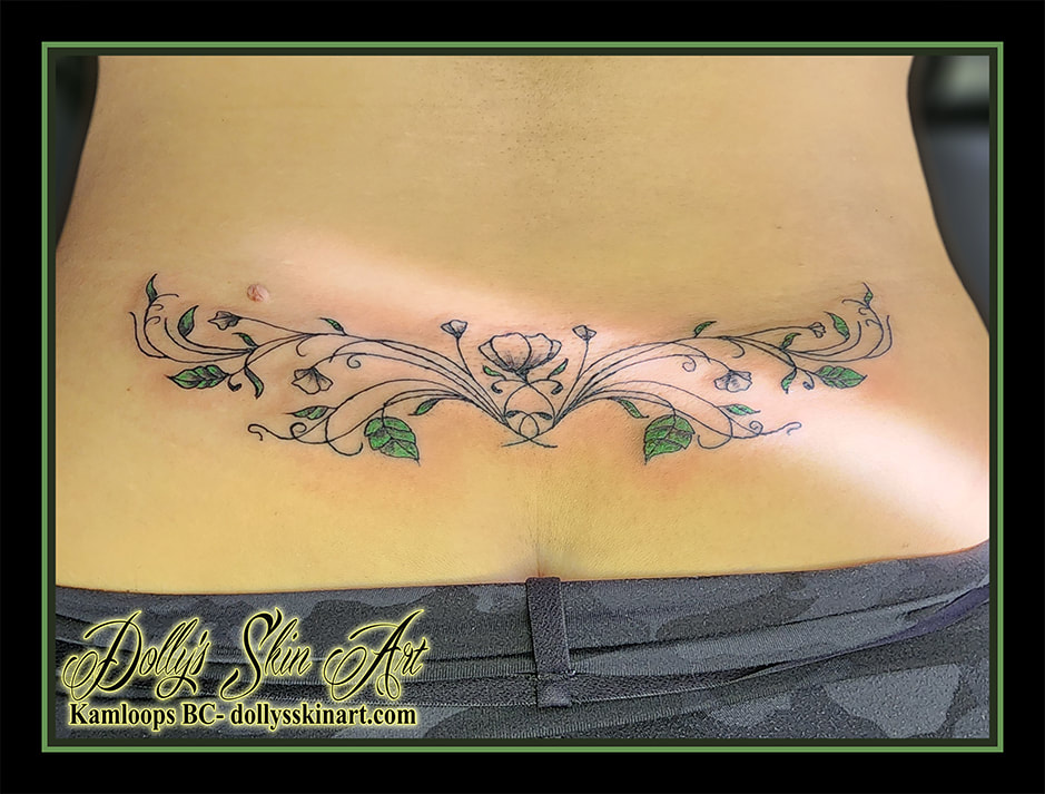 floral tattoo filigree leaves flower black green shading linework lower back tattoo kamloops dolly's skin art