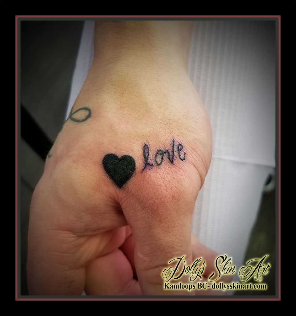 small simple solid black heart love lettering font script hand thumb tattoo kamloops dolly's skin art
