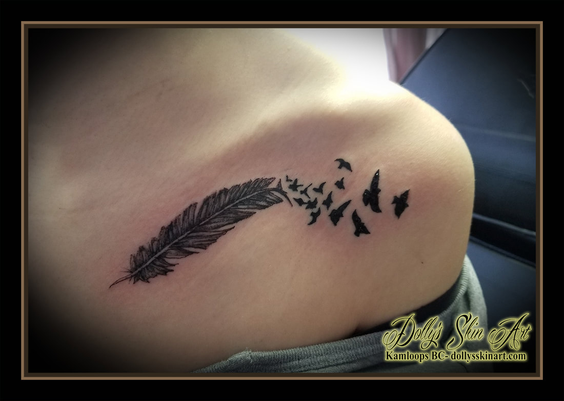 feather tattoo black birds of a feather black and grey shading collarbone chest tattoo kamloops dolly's skin art