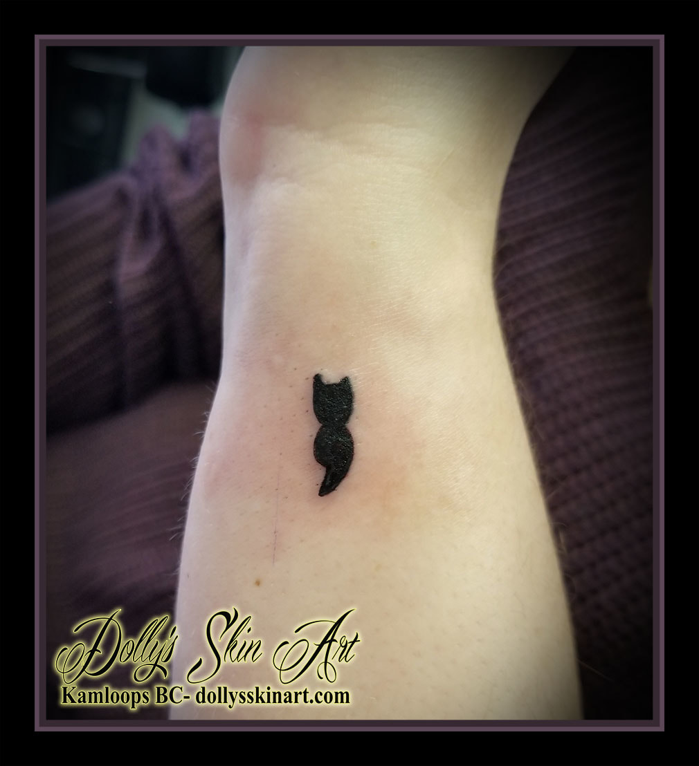 small black silhouette semi colon filled in tattoo kamloops dolly's skin art