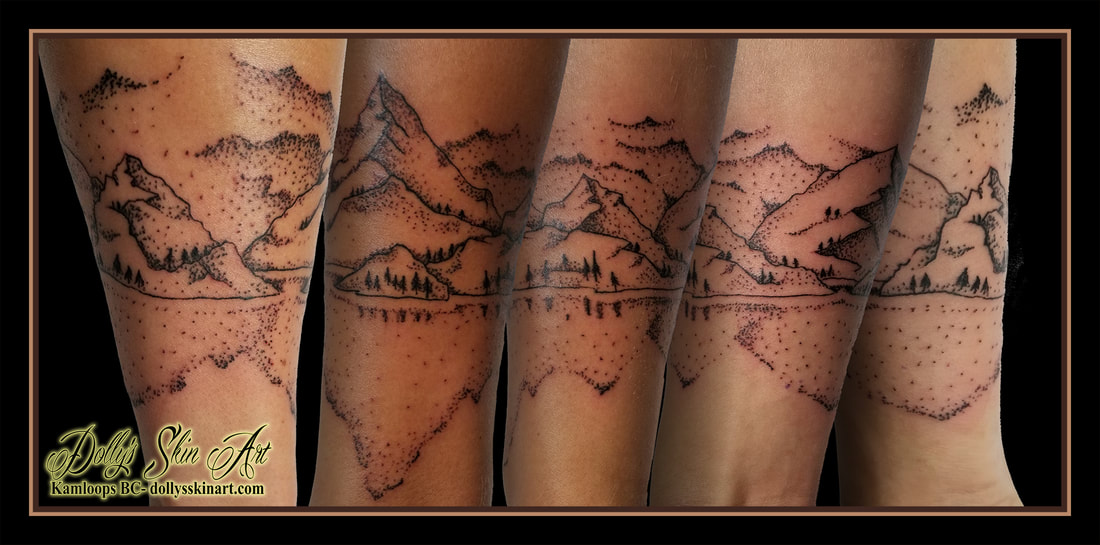 black dotwork mountain scene woods forest water stipple shading forearm wrapping tattoo kamloops dolly's skin art