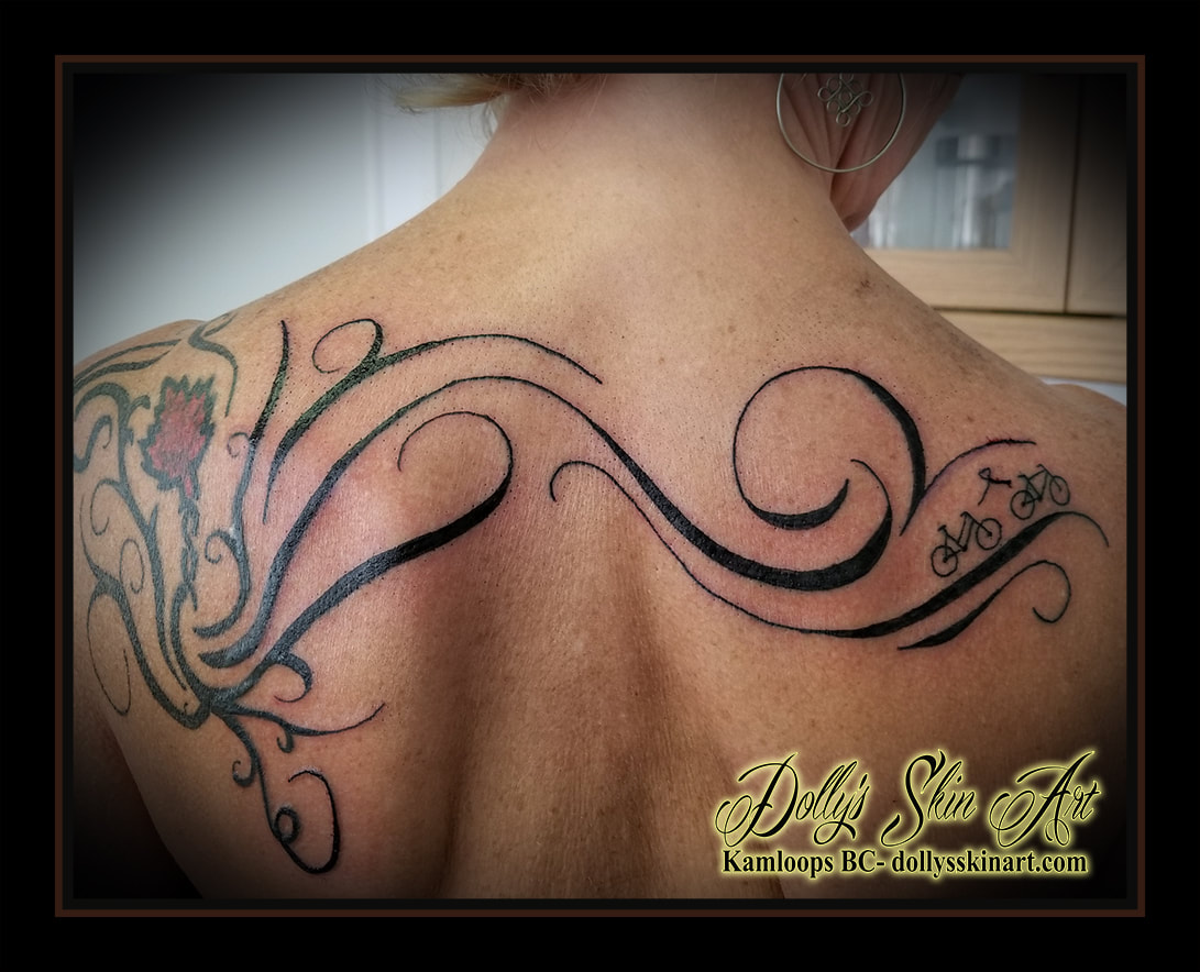 black custom tribal addition maple leaf bicycle ribbon back shoulder tattoo kamloops tattoo dolly's skin art