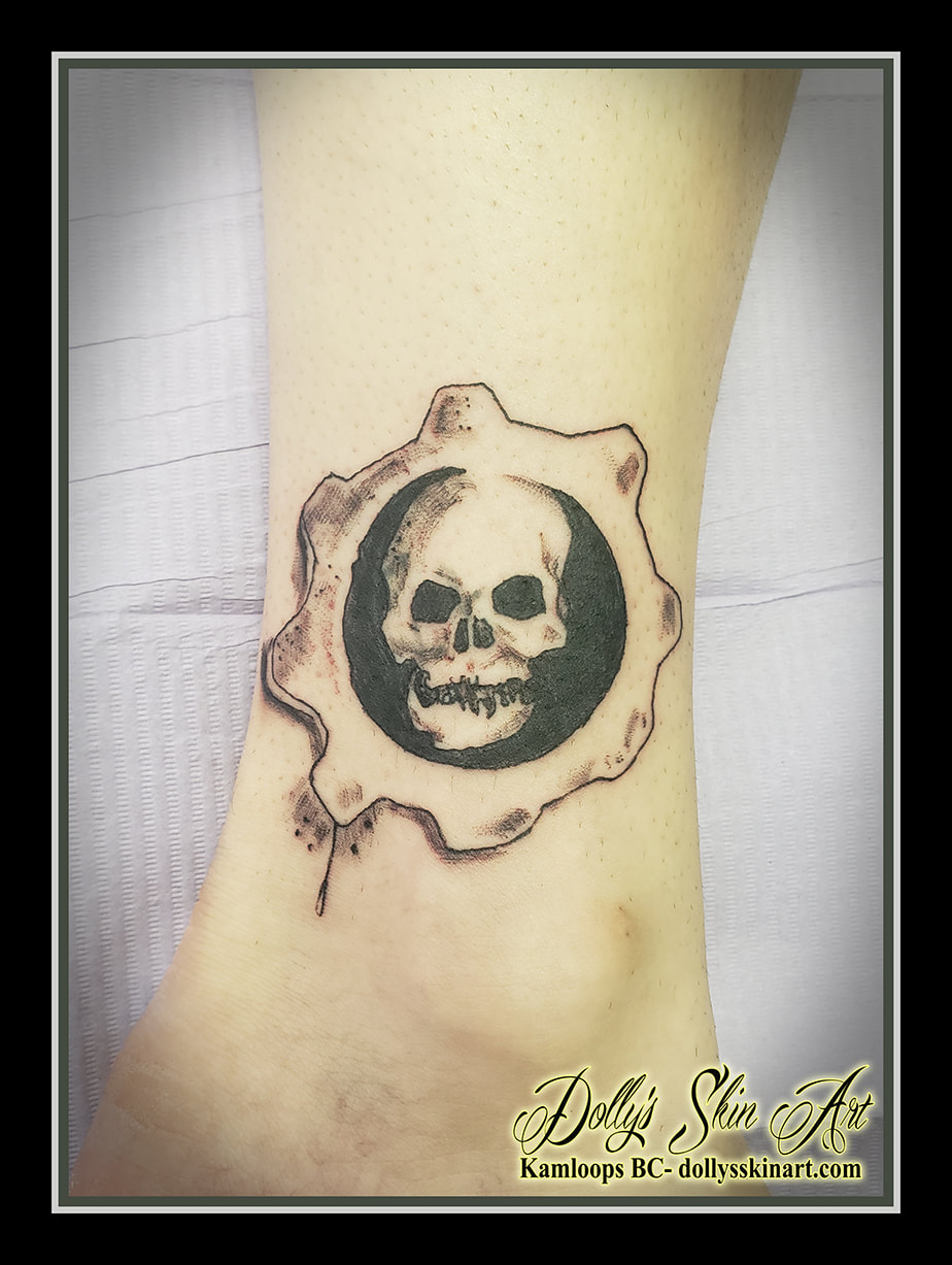 gears of war tattoo logo black and grey game ankle linework shading tattoo dolly's skin art kamloops