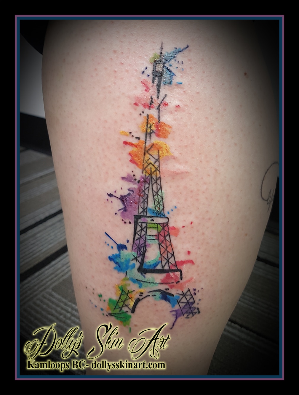 black eiffel tower watercolour green yellow blue purple orange pink leg tattoo kamloops dolly's skin art