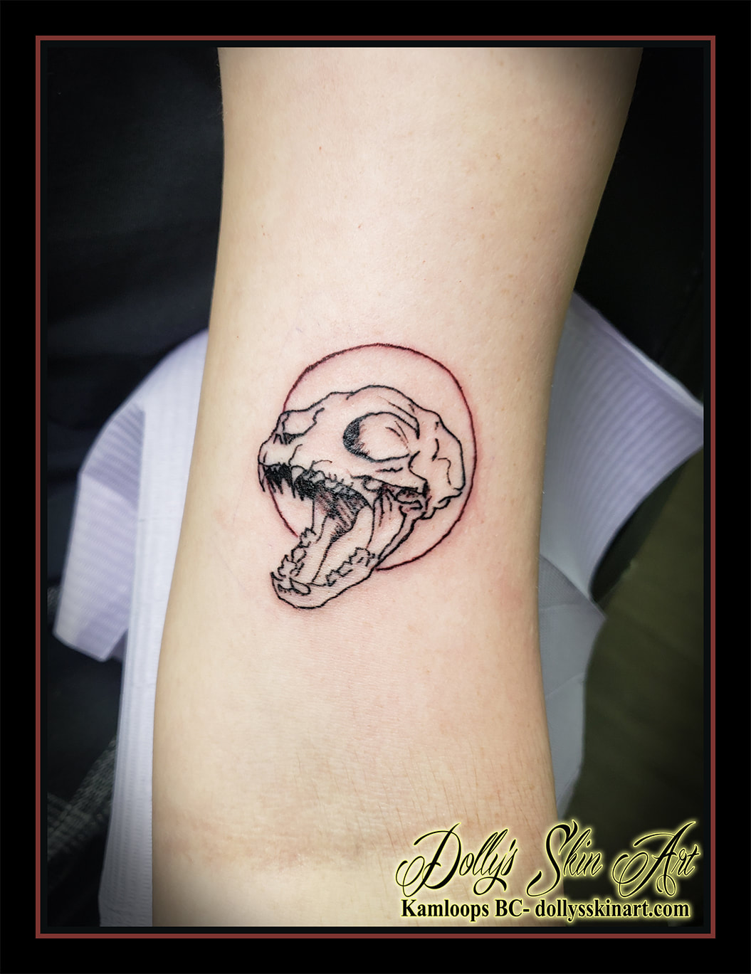 cat tattoo skull red circle black linework arm tattoo dolly's skin art kamloops