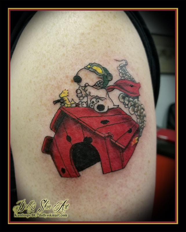 peanuts snoopy tattoo World War I Flying Ace cartoon comic woodstock colour red green yellow doghouse smoke fire red baron wwi shoulder tattoo kamloops tattoo dolly's skin art