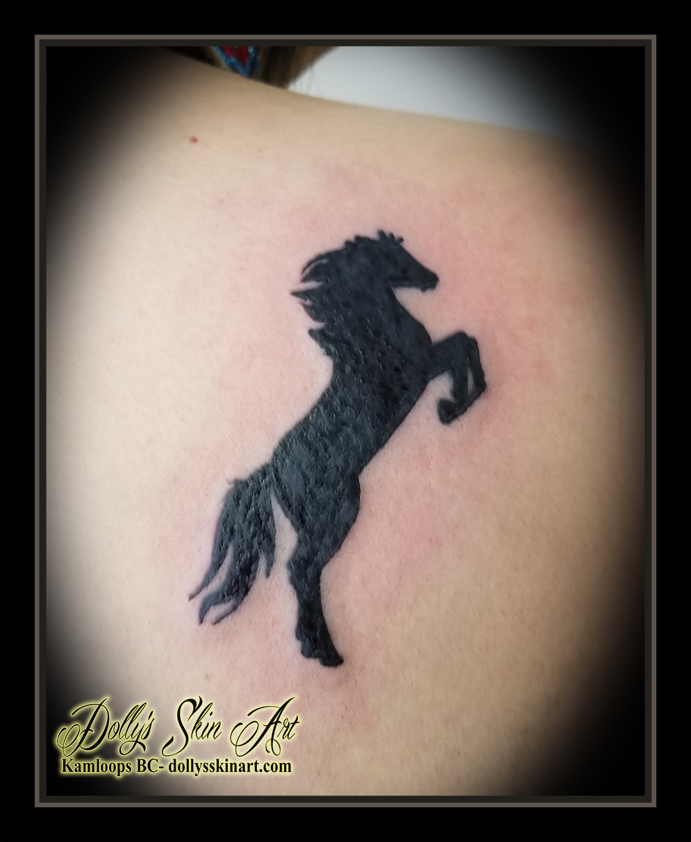 rearing horse silhouette tattoo black solid fill tattoo kamloops dolly's skin art