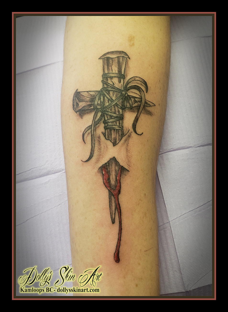 cross tattoo wooden nails leather skin blood black and grey red white forearm tattoo dolly's skin art kamloops