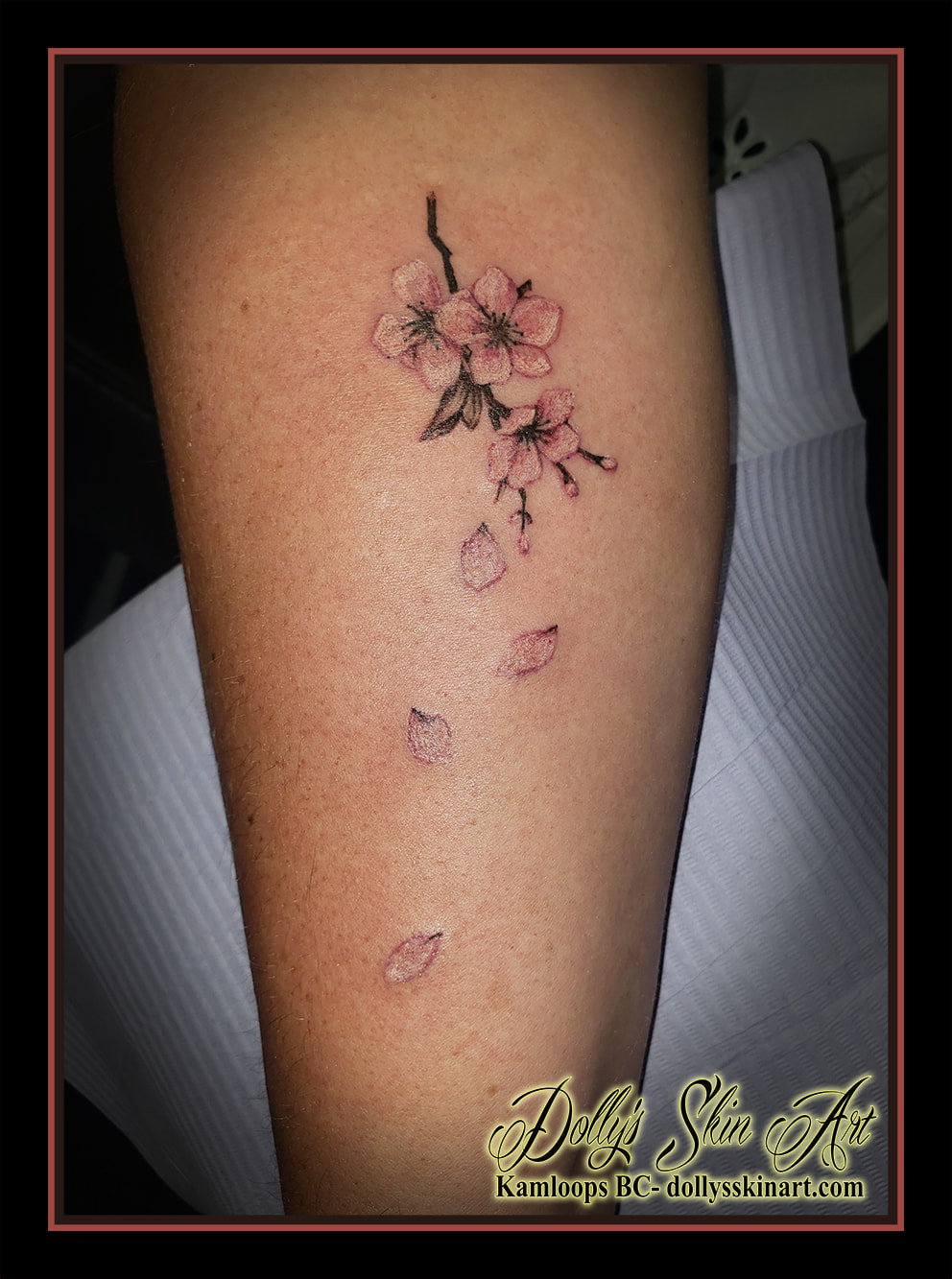 cherry blossom tattoo flower pink white brown leaves petals forearm tattoo kamloops dolly's skin art