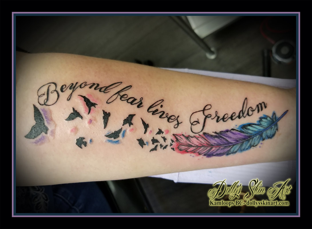 beyond fear lies freedom feather birds flying silhouette watercolour water color pink purple blue lettering script font forearm tattoo kamloops tattoo dolly's skin art