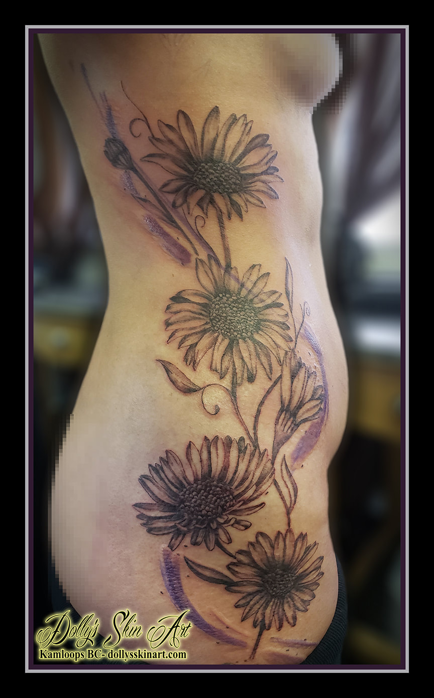 daisies side tattoo black and grey shading purple flowers stems hip ribs side tattoo dolly's skin art kamloops