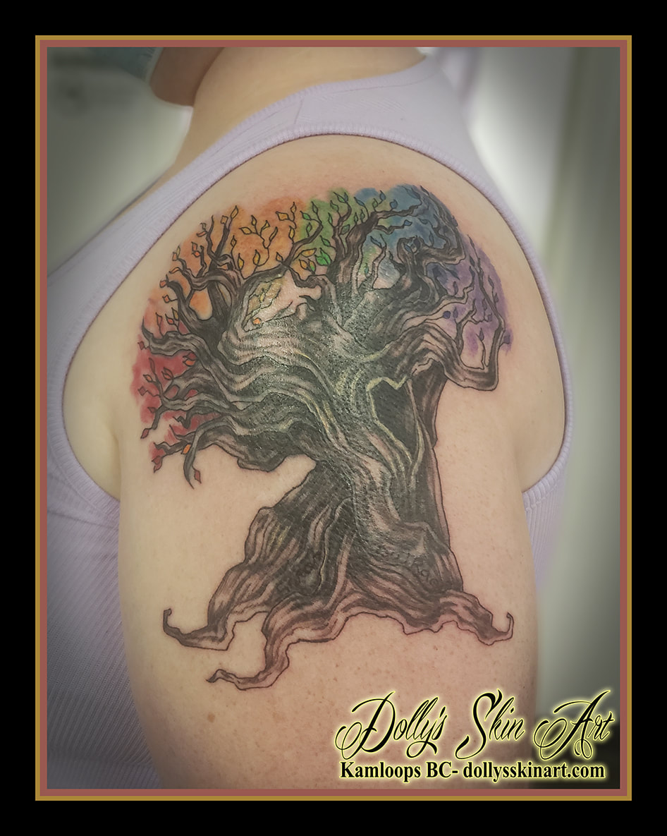 gnarled tree tattoo rainbow leaves colour black names hidden cover up red orange yellow green blue purple shading shoulder tattoo dolly's skin art kamloops