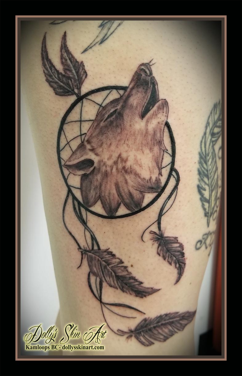 dreamcatcher tattoo wolf black and grey feathers leg thigh howling tattoo kamloops dolly's skin art