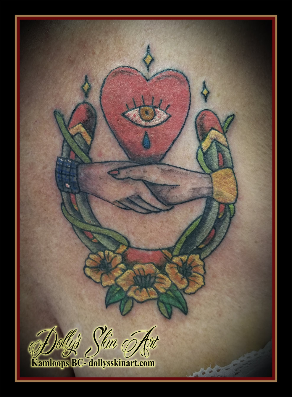 traditional colour horseshoe hands heart eye flowers tattoo kamloops dolly's skin art