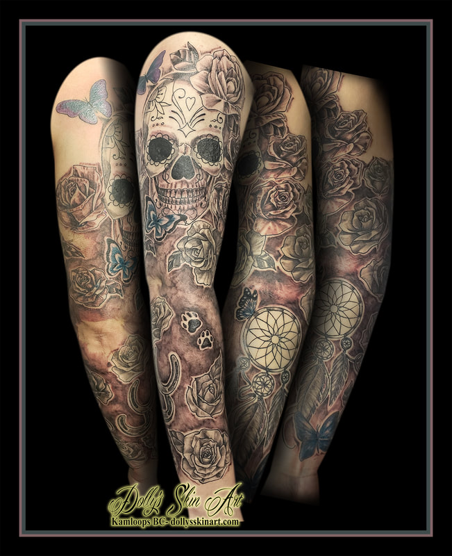 sugar skull tattoo roses flowers butterflies horseshoe dream catcher feather paw print leaves black and grey sleeve shaded blue tattoo kamloops dolly's skin art