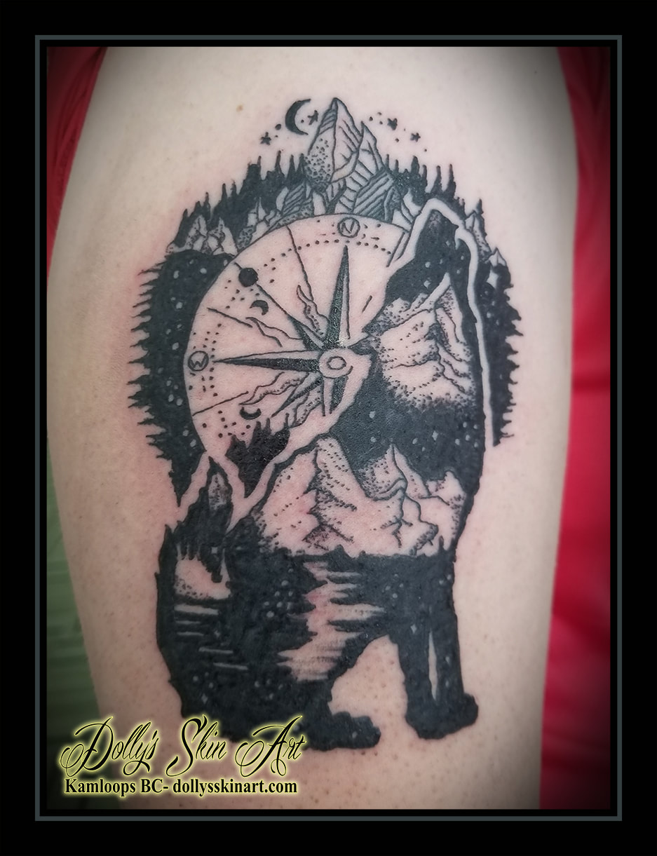 wolf howling tattoo black shading mountains compass trees forest sky blackwork tattoo kamloops dolly's skin art