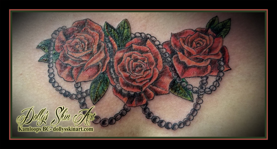 red green roses flowers pearls color small chest tattoo kamloops dolly's skin art