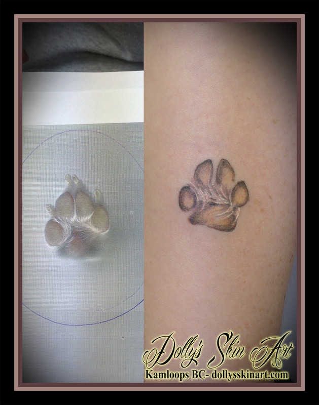 small dog paw print colour arm tattoo kamloops dolly's skin art