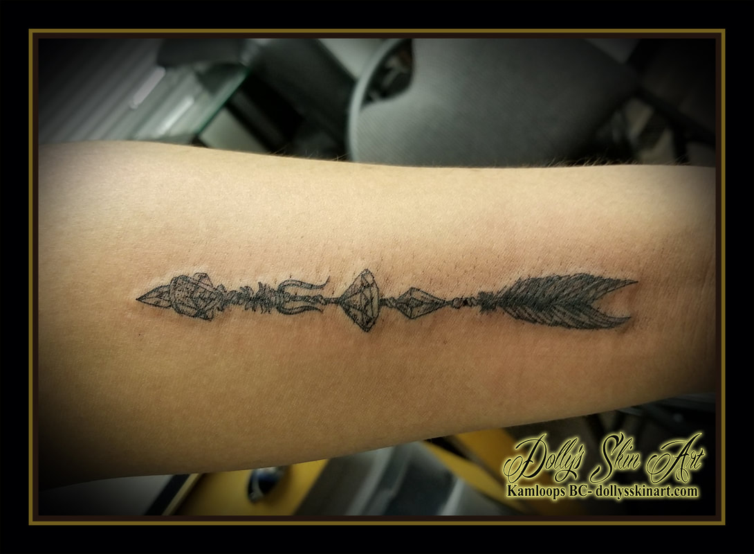black and grey arrow fancy stone diamond feather forearm shading tattoo kamloops tattoo dolly's skin art